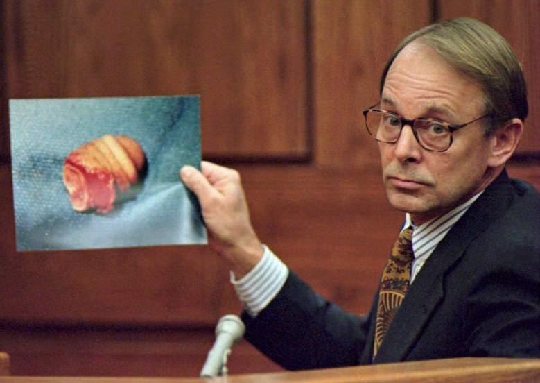 Dr. James T. Sehn holds a photo of the severed pen