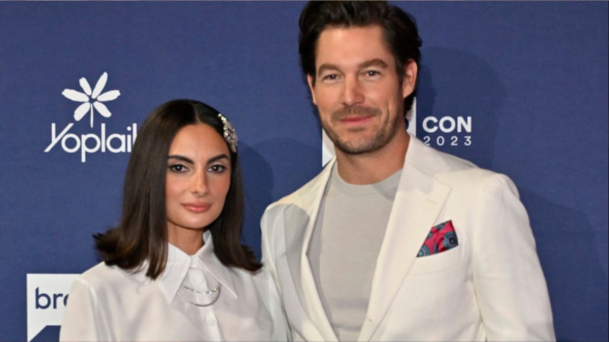 Paige DeSorbo and Craig Conover pose on the red carpet at BravoCon.