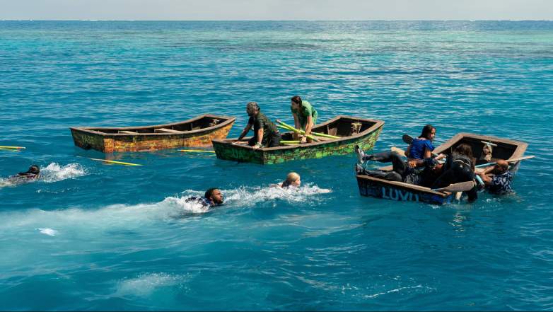 The tribes paddle to shore